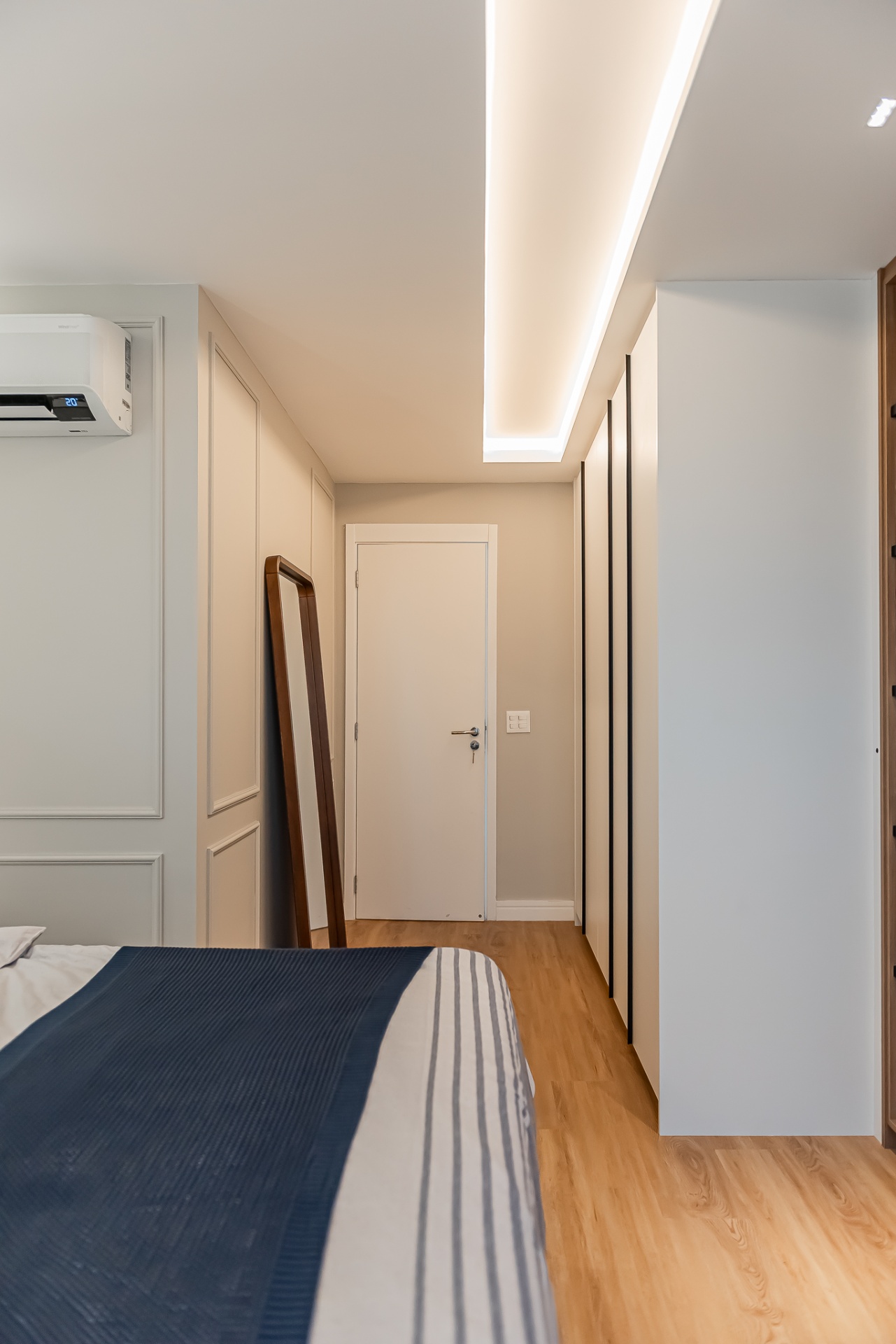 Hall do quarto com boiserie e iluminação indireta
